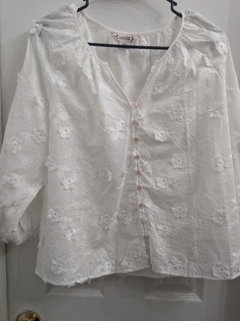 White top with floral detail
